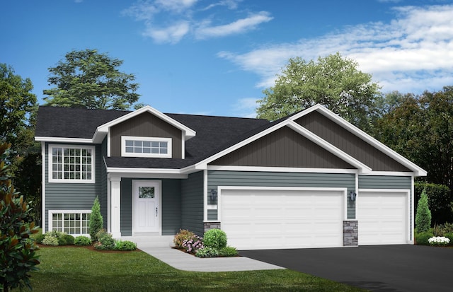 view of front of home with roof with shingles, stone siding, a garage, a front yard, and driveway