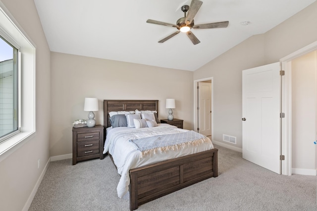 bedroom featuring light colored carpet, a ceiling fan, baseboards, vaulted ceiling, and visible vents