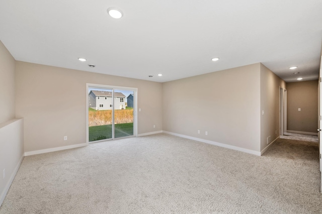 carpeted spare room with recessed lighting and baseboards