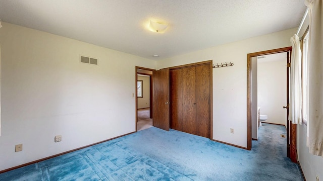 unfurnished bedroom featuring carpet flooring, a closet, and baseboards
