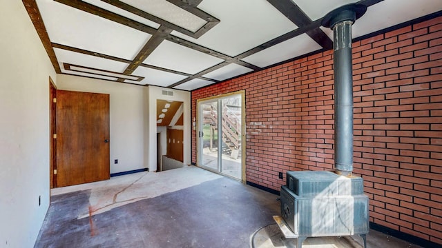 interior space featuring a wood stove and coffered ceiling