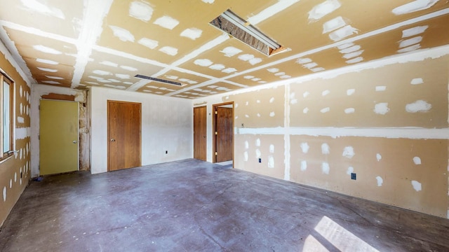 unfurnished room with concrete flooring
