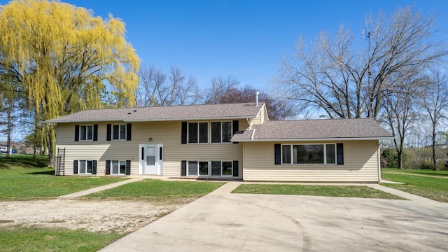 back of property featuring a yard