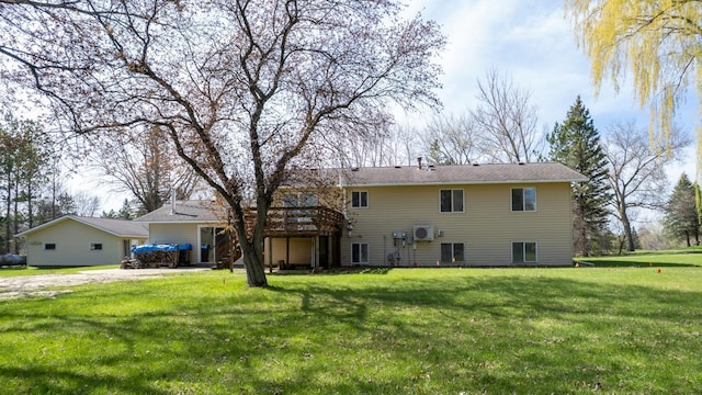 rear view of property with a yard, dirt driveway, and a wooden deck