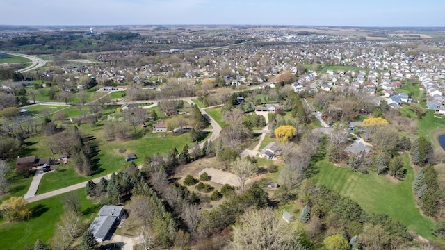 aerial view of property and surrounding area featuring nearby suburban area