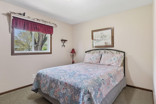carpeted bedroom featuring baseboards