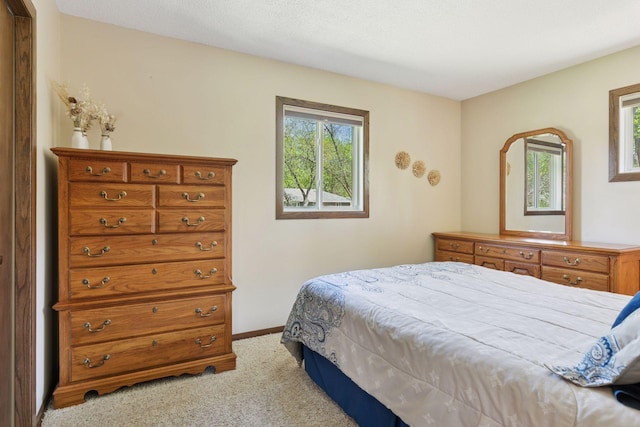 carpeted bedroom with baseboards