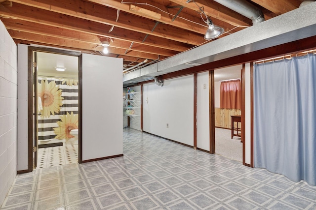 finished basement featuring light flooring
