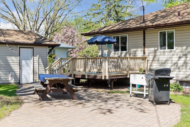 view of patio featuring grilling area and a wooden deck