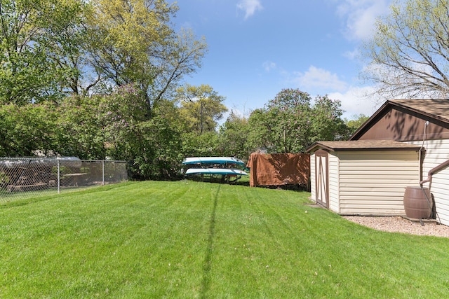 view of yard with a shed and an outbuilding