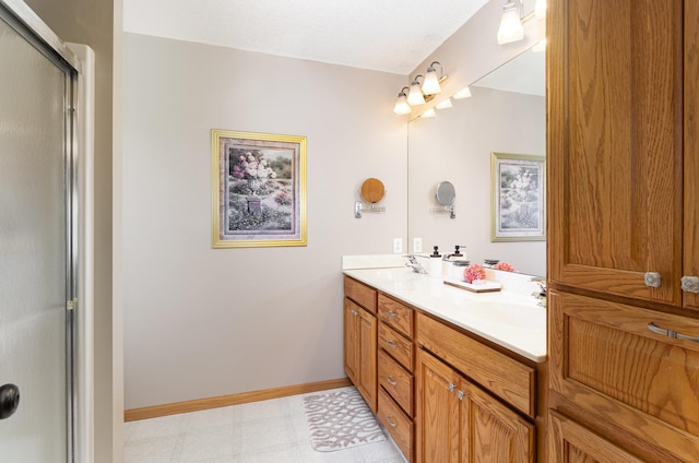 full bath featuring tile patterned floors, double vanity, an enclosed shower, and baseboards