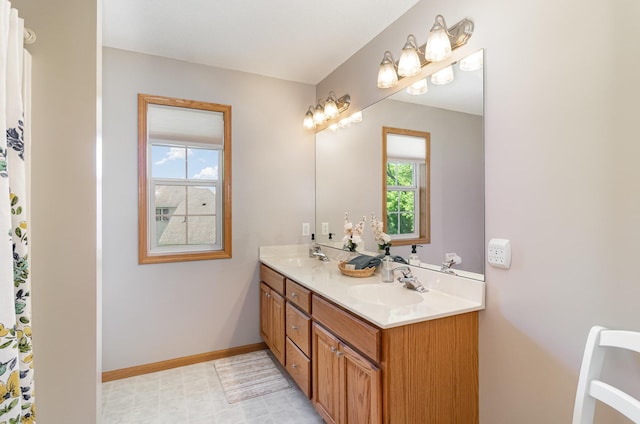 bathroom featuring double vanity and baseboards