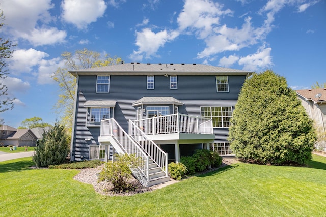 back of house with stairs, a deck, and a yard