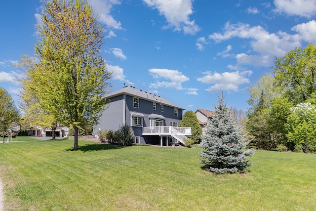 back of house with a wooden deck, stairway, and a yard