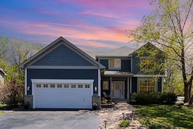 view of front facade with driveway and an attached garage