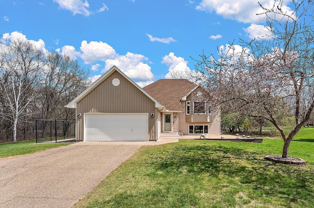 tri-level home featuring fence, a front lawn, a garage, board and batten siding, and driveway