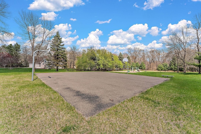 view of basketball court with a lawn and community basketball court