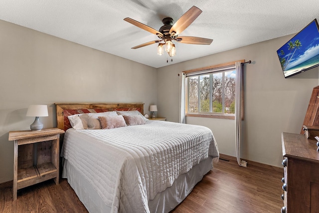 bedroom with ceiling fan and dark wood finished floors