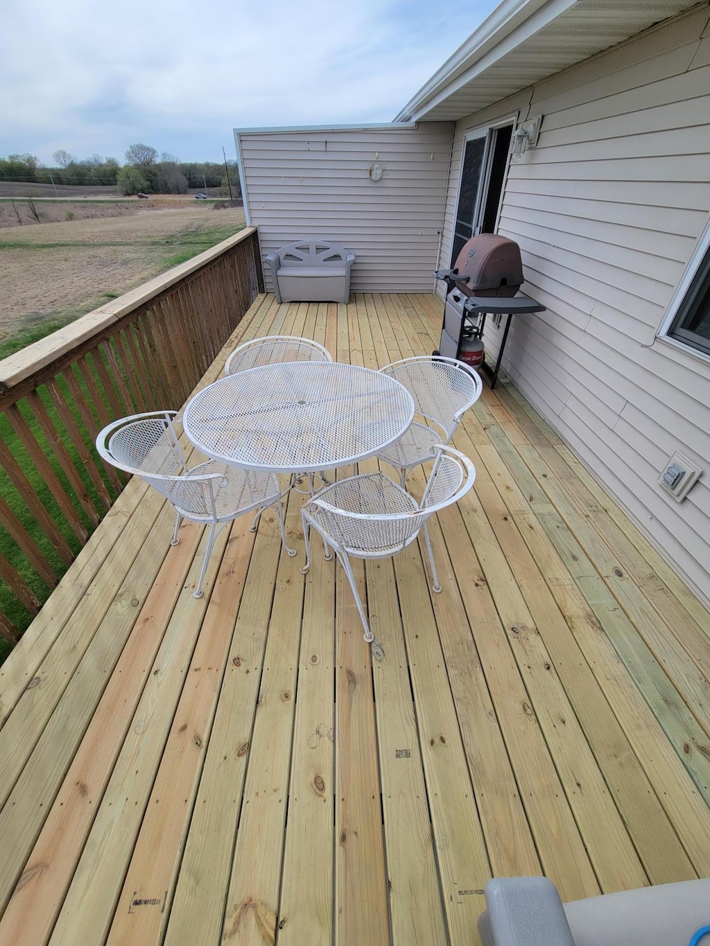 wooden terrace with outdoor dining space