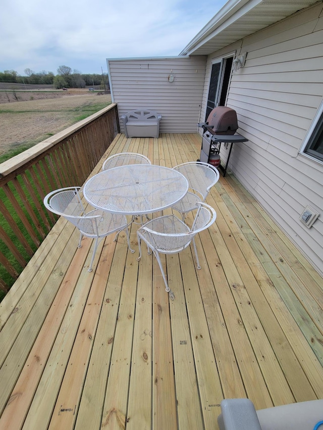 wooden terrace with outdoor dining space