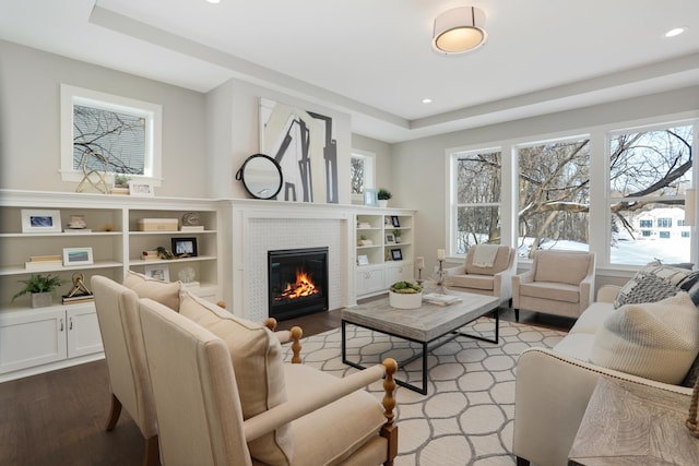 3338 Winfield Way SW, Prior Lake, MN 55372 - living room featuring recessed lighting, a tray ceiling, wood finished floors, and a tile fireplace