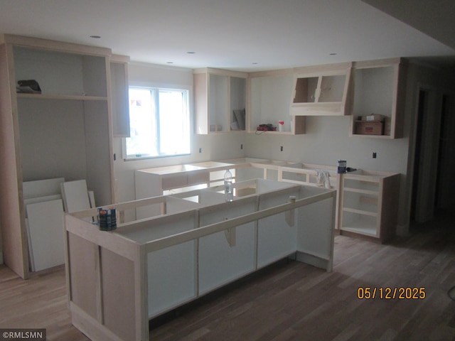 1255 78th St, Victoria, MN 55386 - kitchen with a kitchen island, wood finished floors, and a sink