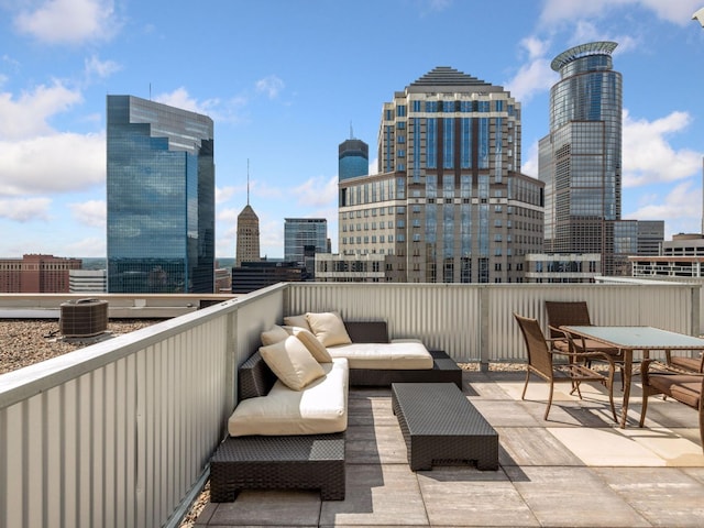 view of patio with central air condition unit, a view of city, and outdoor lounge area