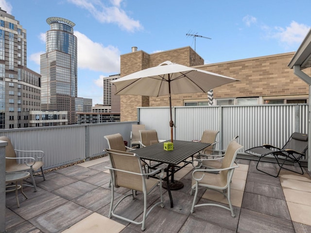view of patio with a city view and outdoor dining space