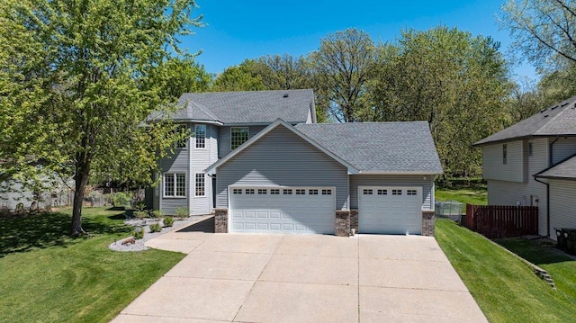9967 Egret Blvd NW, Coon Rapids, MN 55433 - view of front of house featuring a garage, driveway, a shingled roof, and stone siding