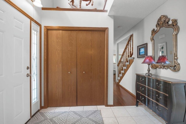 9967 Egret Blvd NW, Coon Rapids, MN 55433 - foyer entrance with light tile patterned floors and stairway