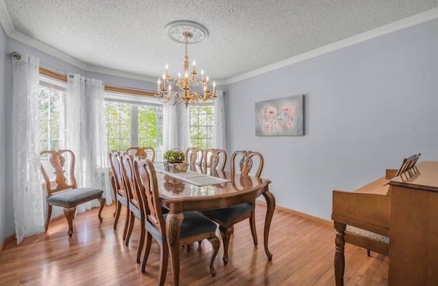 9967 Egret Blvd NW, Coon Rapids, MN 55433 - dining area featuring a textured ceiling, a chandelier, wood-type flooring, ornamental molding, and baseboards