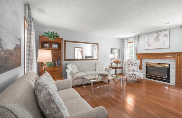 9967 Egret Blvd NW, Coon Rapids, MN 55433 - living room featuring a textured ceiling, wood finished floors, and a fireplace