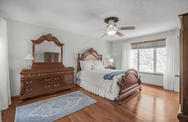 9967 Egret Blvd NW, Coon Rapids, MN 55433 - bedroom featuring a textured ceiling, wood finished floors, baseboards, and ceiling fan