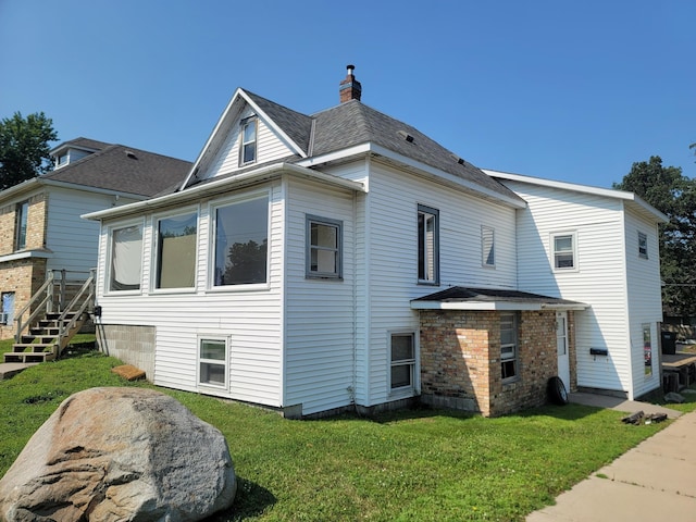157 10th Ave N, Waite Park, MN 56387 - back of house featuring a chimney and a yard