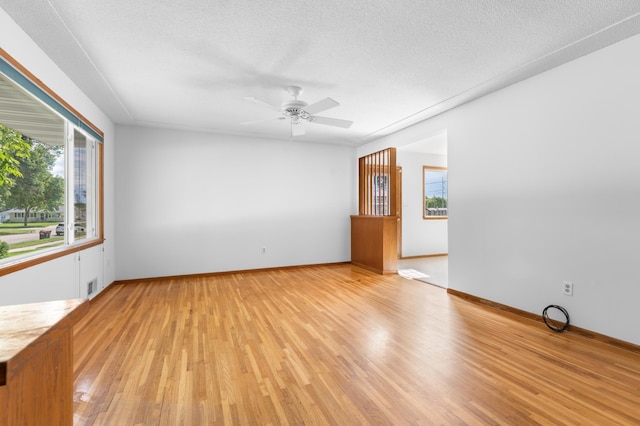 3618 1st St NW, Rochester, MN 55901 - unfurnished room featuring light wood-style floors, a ceiling fan, and a textured ceiling
