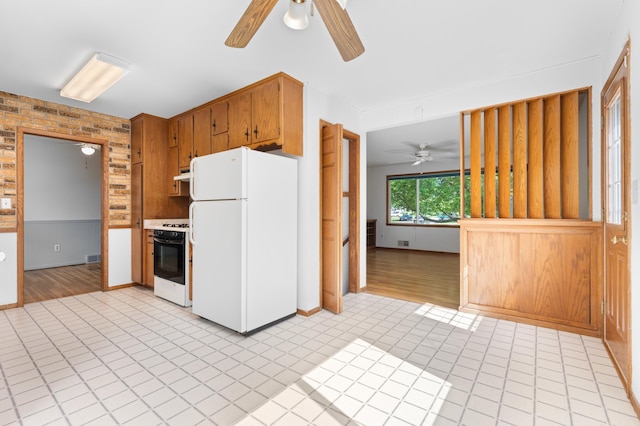 3618 1st St NW, Rochester, MN 55901 - kitchen with white appliances, ceiling fan, under cabinet range hood, light tile patterned floors, and wainscoting