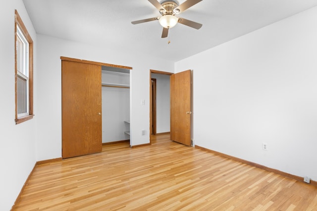3618 1st St NW, Rochester, MN 55901 - unfurnished bedroom with light wood-style flooring, a closet, and a ceiling fan