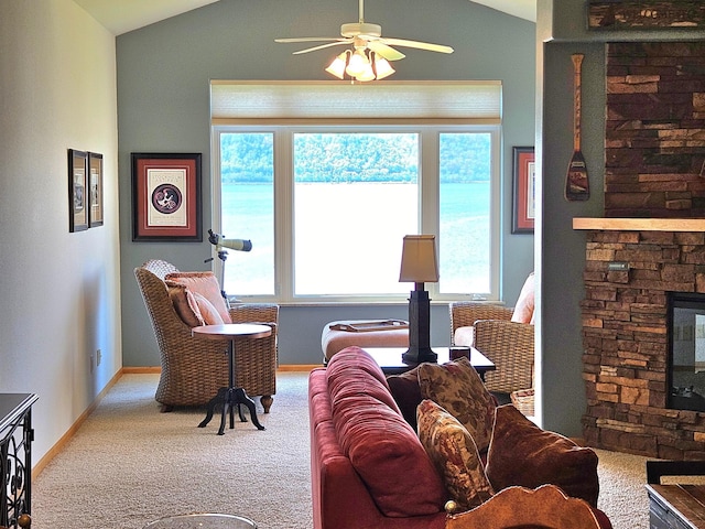 living area with lofted ceiling, carpet floors, plenty of natural light, a ceiling fan, and baseboards