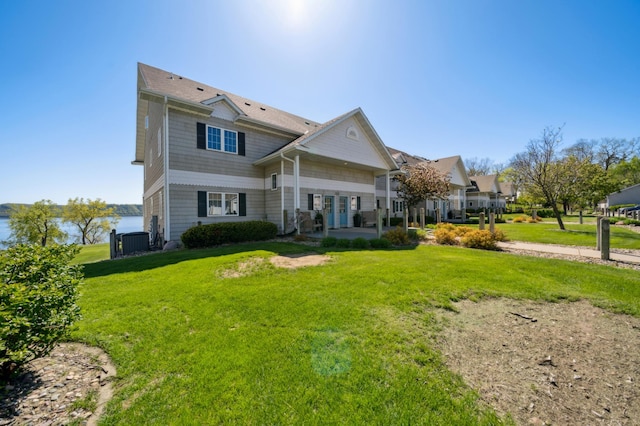 rear view of property featuring a lawn and a patio area