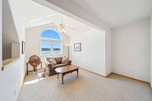 carpeted living area featuring ceiling fan, lofted ceiling, baseboards, and a water view