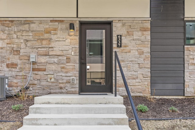 entrance to property with stone siding