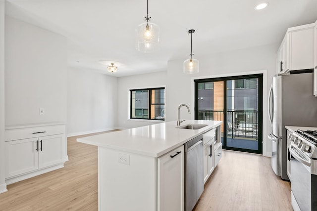 kitchen featuring a sink, range with gas cooktop, stainless steel dishwasher, and light wood finished floors