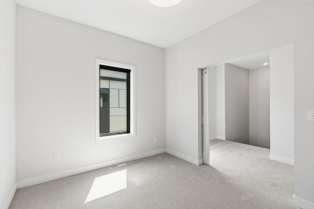unfurnished room featuring carpet floors, baseboards, and visible vents