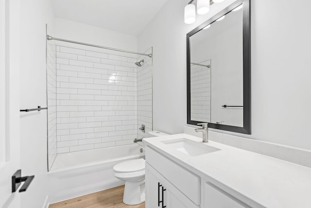 full bath featuring vanity, bathing tub / shower combination, toilet, and wood finished floors