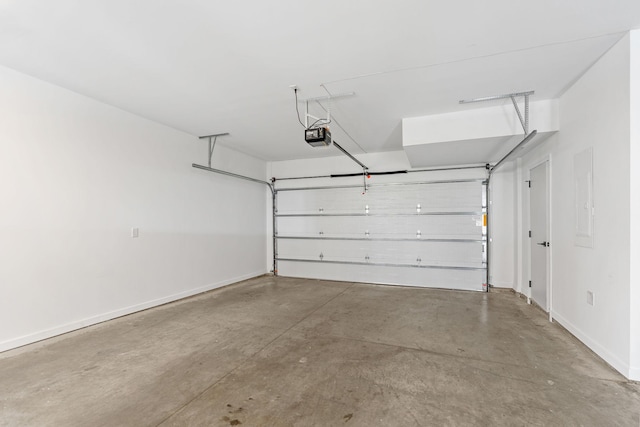 garage with baseboards and a garage door opener
