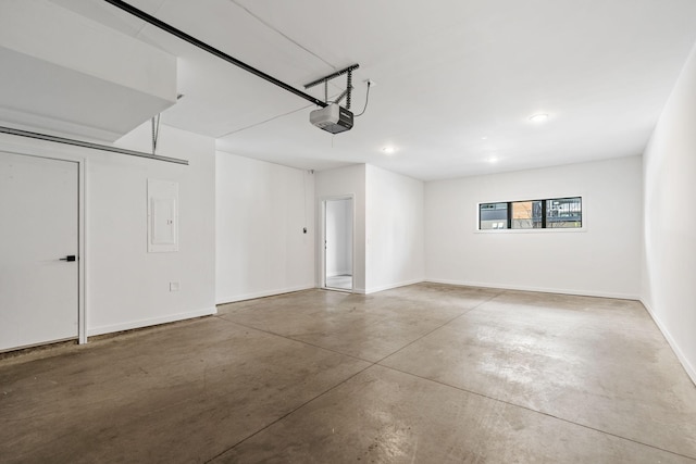 garage with baseboards, a garage door opener, and recessed lighting