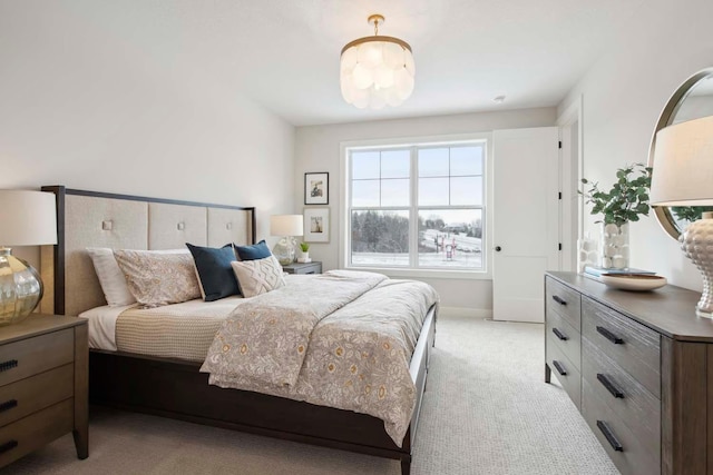 bedroom featuring baseboards and light carpet