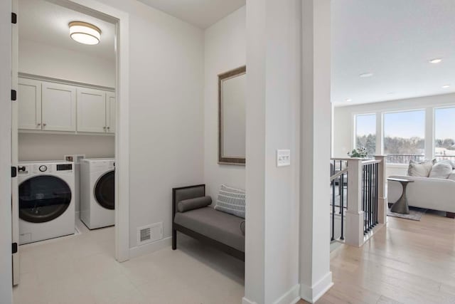 laundry area featuring visible vents, cabinet space, baseboards, separate washer and dryer, and recessed lighting