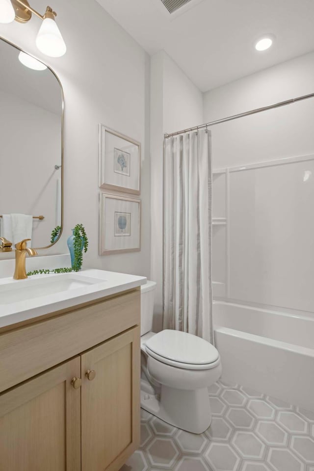 full bathroom featuring vanity, shower / bath combination with curtain, and toilet