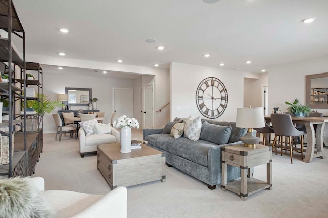 living area with recessed lighting and light carpet
